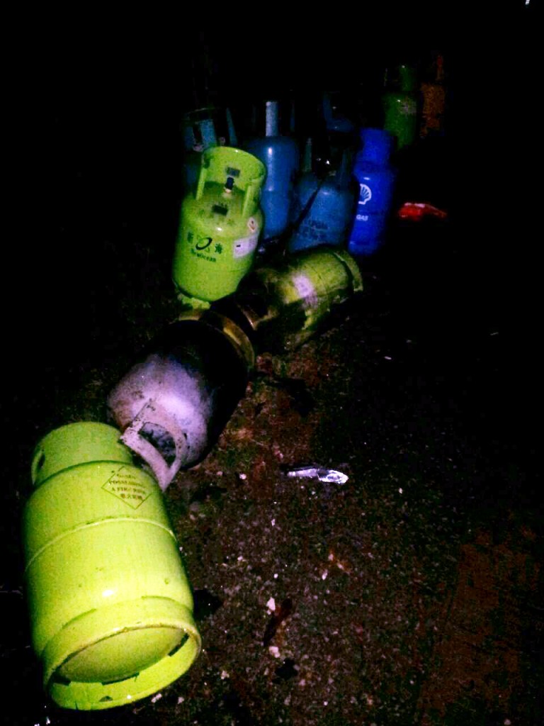 Gas cylinders removed from the slum with rusty gate